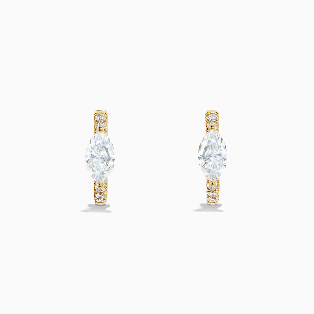 Lab Grown Diamond Marquise Huggie Earrings in 14K Yellow Gold, each showcasing a central round diamond and smaller accent diamonds along the vertical sides, displayed on a plain white background.