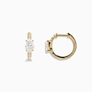 Lab Grown Diamond Oval Huggie Earrings in 14K Yellow Gold, each with a central oval lab diamond and smaller round lab diamonds on the front, are shown against a plain white background.
