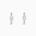 Lab Grown Diamond Round Huggie Earrings in 14K White Gold, featuring a central round diamond with vertical rows of smaller diamonds, displayed on a plain white background.