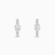 Lab Grown Diamond Round Huggie Earrings in 14K White Gold, featuring a central round diamond with vertical rows of smaller diamonds, displayed on a plain white background.