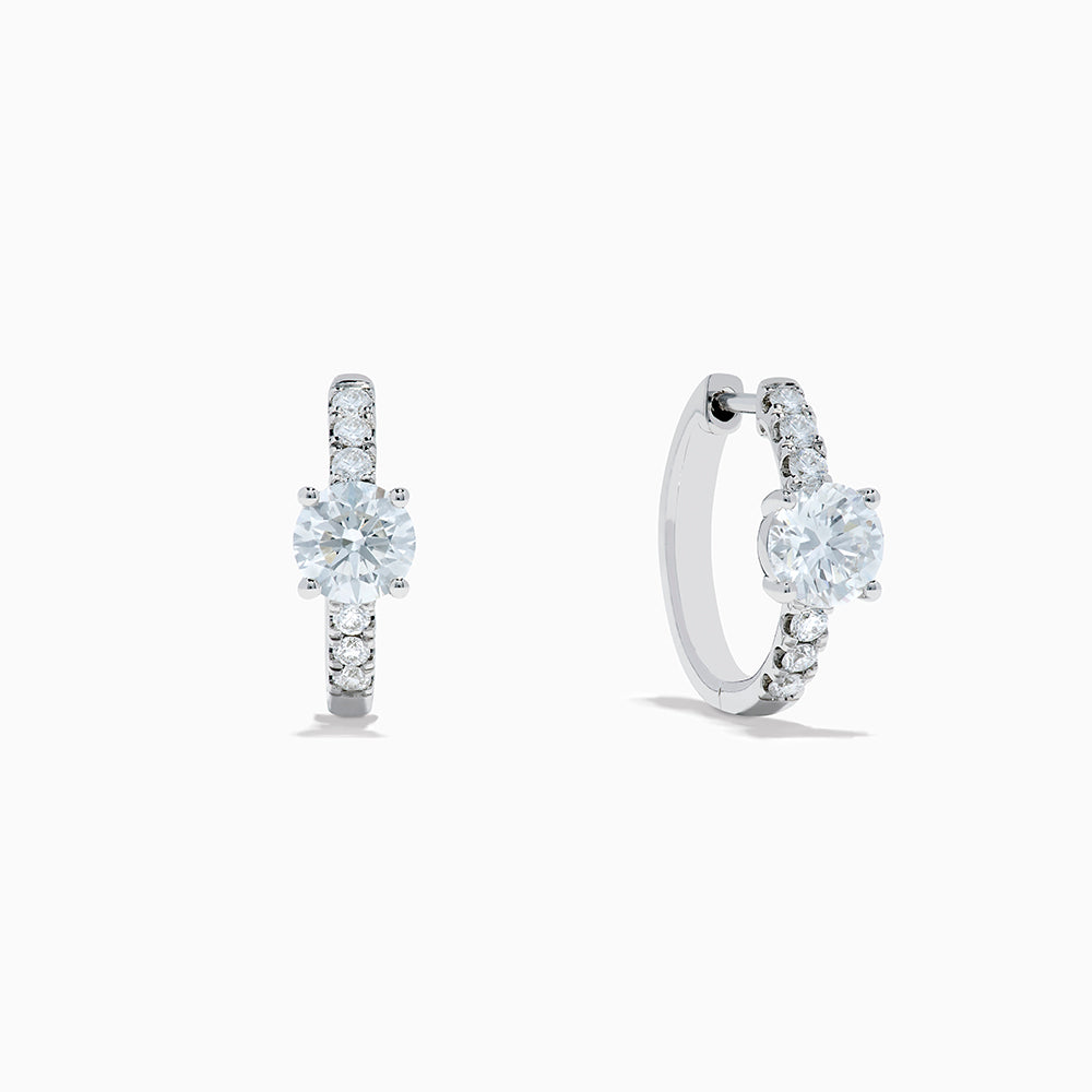Lab Grown Diamond Round Huggie Earrings in 14K White Gold, featuring a central round diamond with vertical rows of smaller diamonds, displayed on a plain white background.