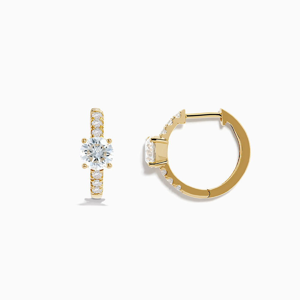 The Lab Grown Diamond Round Huggie Earrings in 14K Yellow Gold feature a central round lab diamond accented by a row of smaller lab diamonds, all set in sleek yellow gold and displayed on a white background.