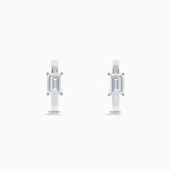 A pair of Lab Grown Diamond Emerald-Cut Huggie Earrings in 14K White Gold, each featuring a vertically set emerald-cut lab diamond at the front, displayed against a plain white background.