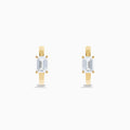 A pair of Lab Grown Diamond Emerald-Cut Huggie Earrings in 14K Yellow Gold is shown on a plain white background, each earring featuring a vertically set emerald-cut lab grown diamond at the center.