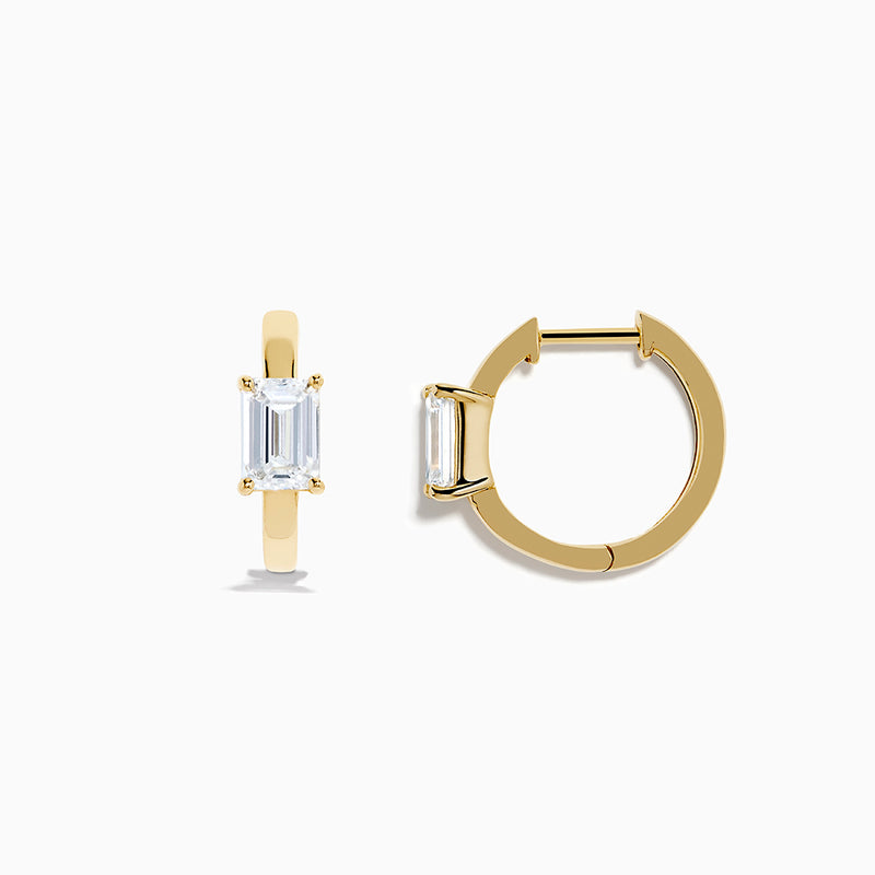 A pair of Lab Grown Diamond Emerald-Cut Huggie Earrings in 14K Yellow Gold is shown on a plain white background, each earring featuring a vertically set emerald-cut lab grown diamond at the center.