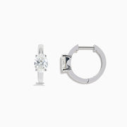 A pair of Lab Grown Diamond Oval Huggie Earrings in 14K white gold, each adorned with sparkling diamonds in a sleek, modern setting, displayed on a plain white background.