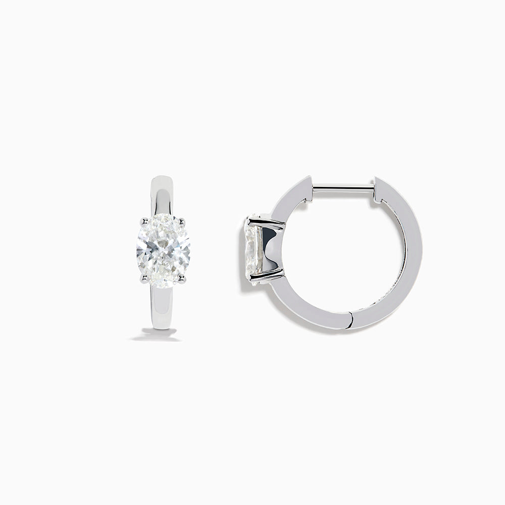 A pair of Lab Grown Diamond Oval Huggie Earrings in 14K white gold, each adorned with sparkling diamonds in a sleek, modern setting, displayed on a plain white background.