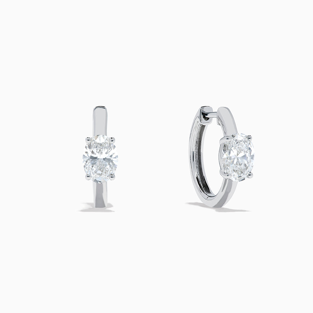 A pair of Lab Grown Diamond Oval Huggie Earrings in 14K white gold, each adorned with sparkling diamonds in a sleek, modern setting, displayed on a plain white background.