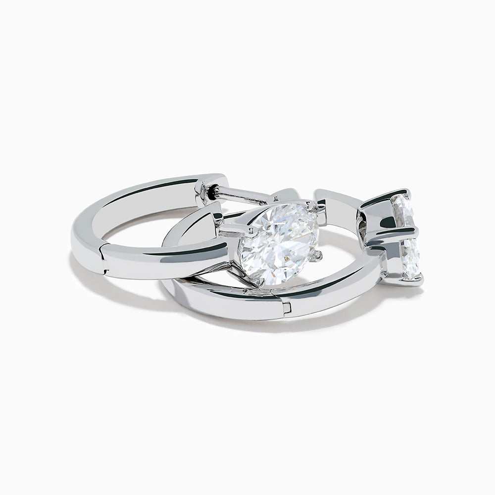 A pair of Lab Grown Diamond Oval Huggie Earrings in 14K white gold, each adorned with sparkling diamonds in a sleek, modern setting, displayed on a plain white background.