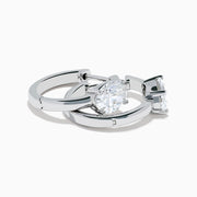A pair of Lab Grown Diamond Oval Huggie Earrings in 14K white gold, each adorned with sparkling diamonds in a sleek, modern setting, displayed on a plain white background.