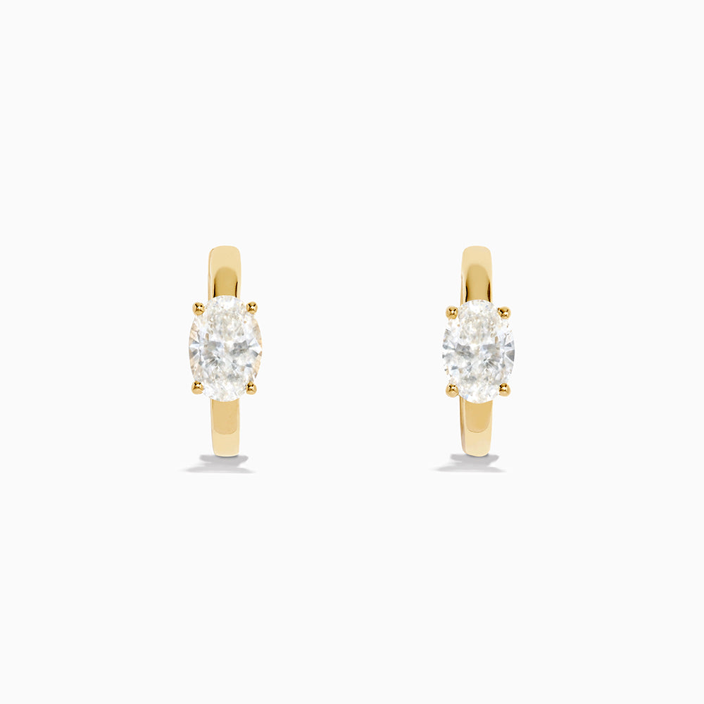 Lab Grown Diamond Oval Huggie Earrings in 14K Yellow Gold, each featuring a single oval lab grown diamond, displayed on a plain white background.