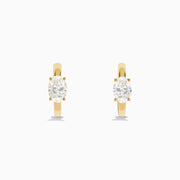 Lab Grown Diamond Oval Huggie Earrings in 14K Yellow Gold, each featuring a single oval lab grown diamond, displayed on a plain white background.