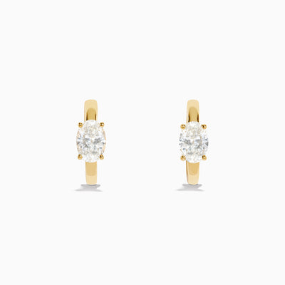 Lab Grown Diamond Oval Huggie Earrings in 14K Yellow Gold, each featuring a single oval lab grown diamond, displayed on a plain white background.