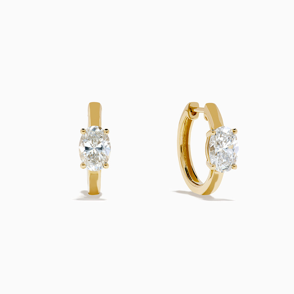 Lab Grown Diamond Oval Huggie Earrings in 14K Yellow Gold, each featuring a single oval lab grown diamond, displayed on a plain white background.