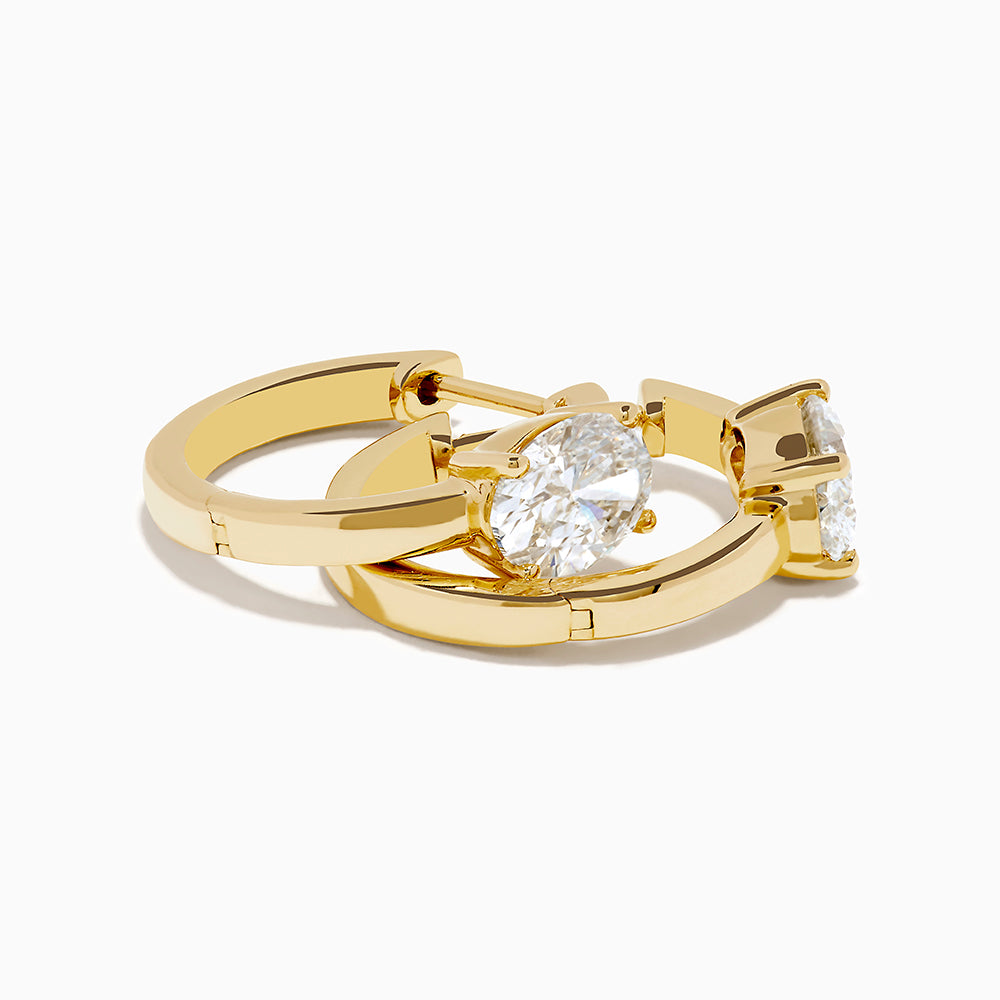 Lab Grown Diamond Oval Huggie Earrings in 14K Yellow Gold, each featuring a single oval lab grown diamond, displayed on a plain white background.