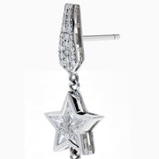 The 18K White Gold Diamond Shooting Star Linear Drop Earrings showcase a central star design with a long, pointed diamond-encrusted dangle, displayed on a plain white background.