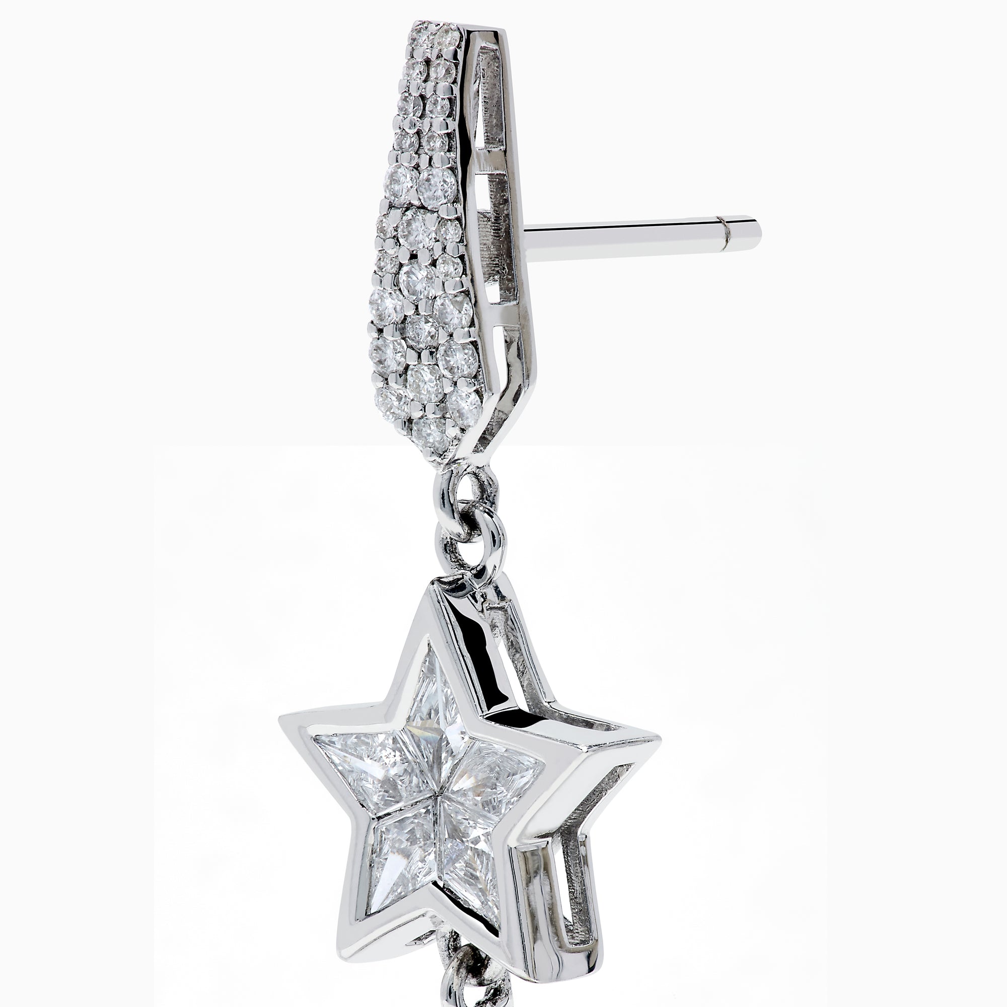 The 18K White Gold Diamond Shooting Star Linear Drop Earrings showcase a central star design with a long, pointed diamond-encrusted dangle, displayed on a plain white background.