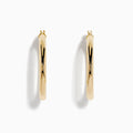 The 14K Yellow Gold Hollow Tube Hoops are sleek, polished earrings shown side by side against a white background, featuring classic yellow gold in a timeless hoop design with clasps at the top.