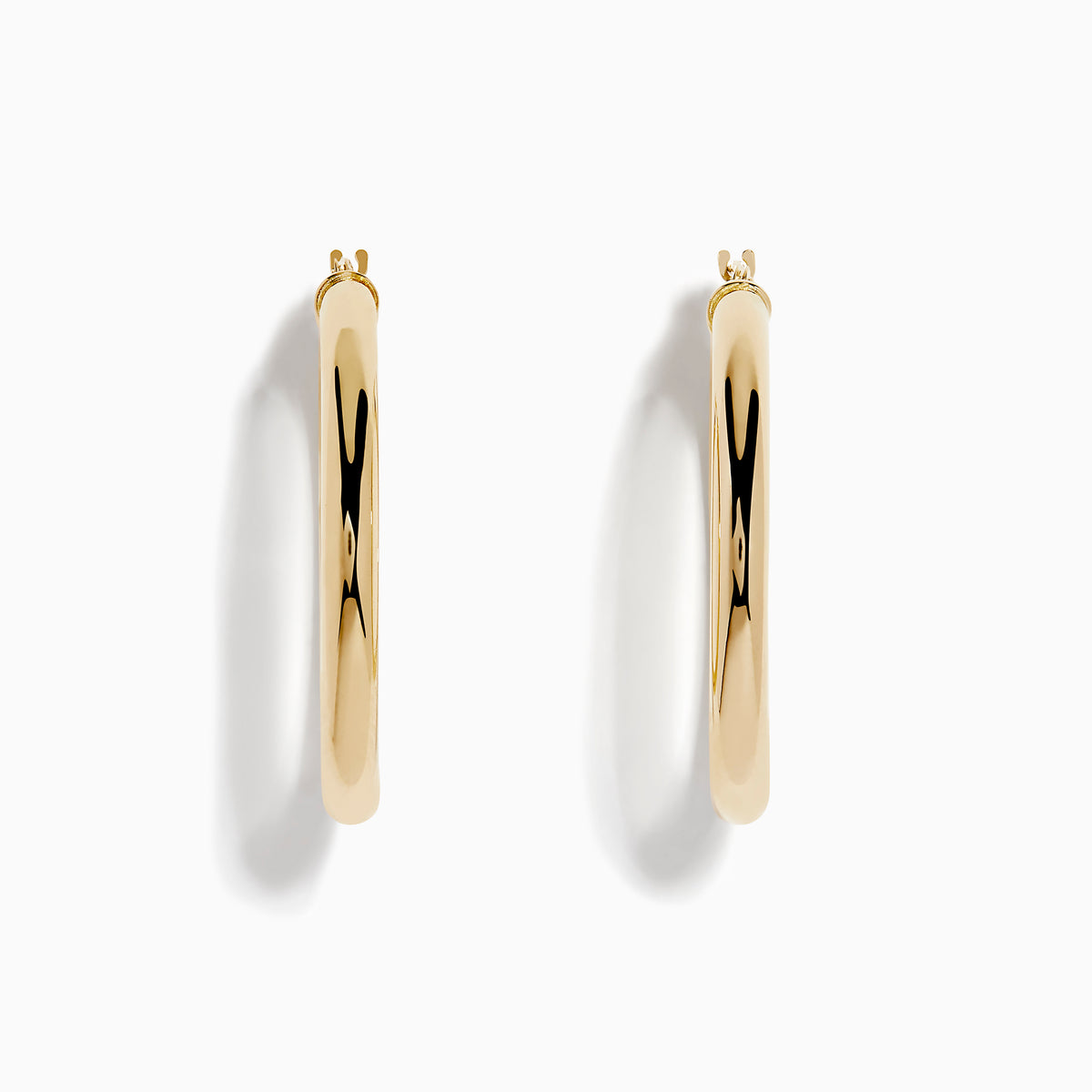 The 14K Yellow Gold Hollow Tube Hoops are sleek, polished earrings shown side by side against a white background, featuring classic yellow gold in a timeless hoop design with clasps at the top.