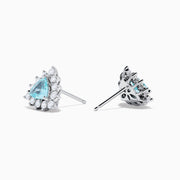 A pair of 18K white gold GIA certified Paraiba and diamond stud earrings with triangular blue gems surrounded by a halo of small diamonds, set in silver, displayed on a white background.
