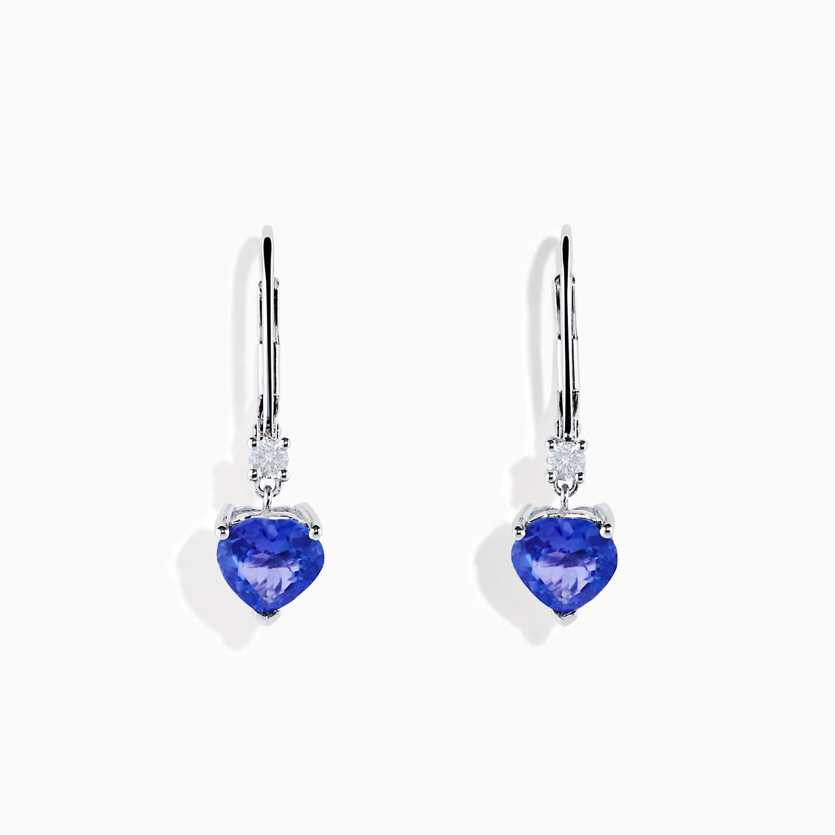The Nahla Siri 14K White Gold Tanzanite and Diamond Leverback Earrings feature heart-shaped blue tanzanite stones accented with sparkling diamonds, shown on a white background.