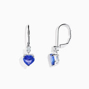 The Nahla Siri 14K White Gold Tanzanite and Diamond Leverback Earrings feature heart-shaped blue tanzanite stones accented with sparkling diamonds, shown on a white background.