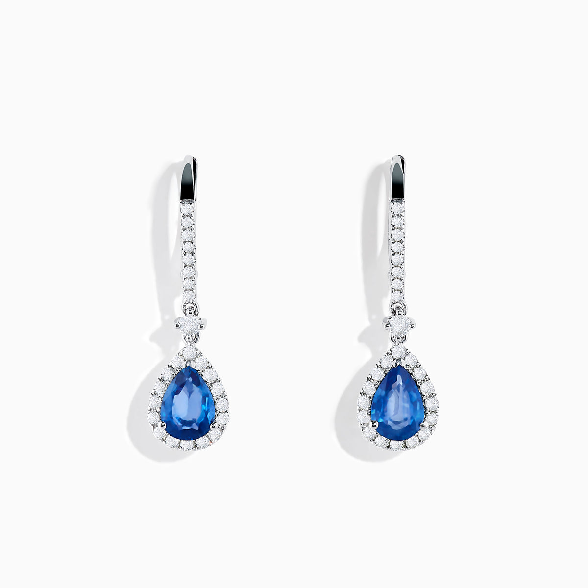 The 14K White Gold Pear Shape Blue Sapphire and Diamond Drop Earrings feature teardrop-shaped sapphires surrounded by white diamonds, set in elegant white gold, shown on a white background.