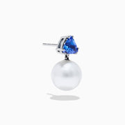 The Nahla 14K White Gold Fresh Water Pearl and Tanzanite Earrings feature round white pearls suspended below triangular blue tanzanite gemstones, set in white gold, displayed on a white background.