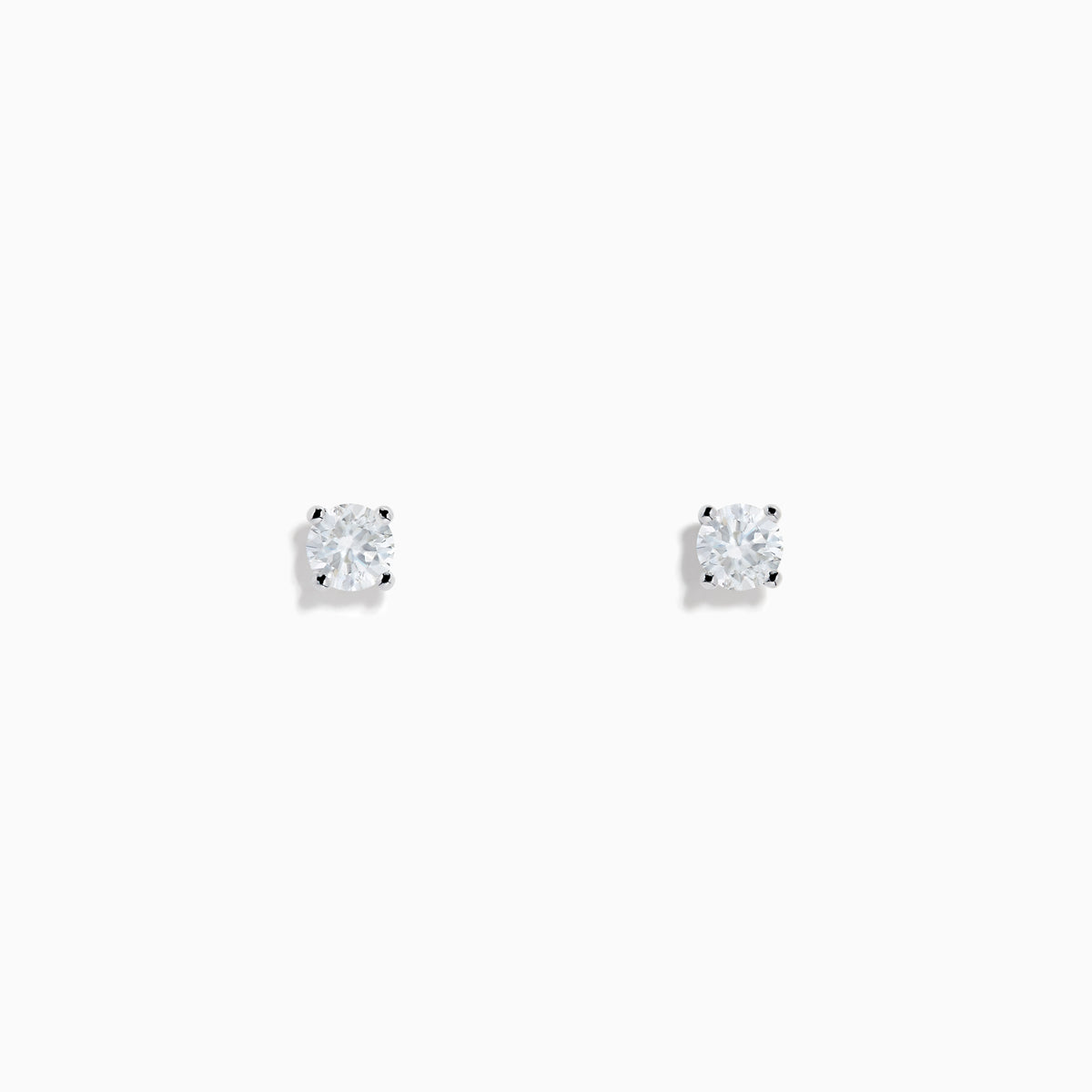 Two 14 karat white gold diamond stud earrings with 0.40TCW round diamonds shine in silver prong settings against a white background—perfect for timeless elegance.