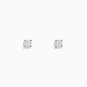 A pair of 14 Karat white gold stud earrings featuring 0.63TCW round diamonds is displayed on a simple white background, highlighting their timeless elegance.