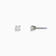 A pair of 14 Karat white gold stud earrings featuring 0.63TCW round diamonds is displayed on a simple white background, highlighting their timeless elegance.