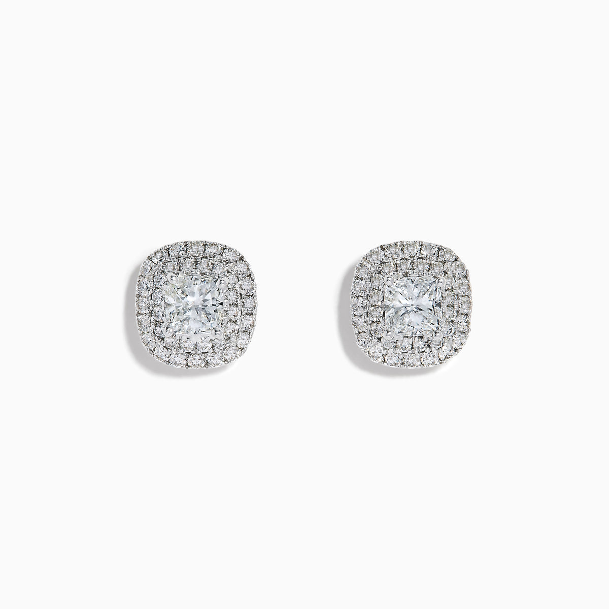 The 18K White Gold Diamond Double Halo Cushion Stud Earrings feature cushion-cut diamonds surrounded by double halos of smaller diamonds, set in 18K white gold and displayed on a white background.