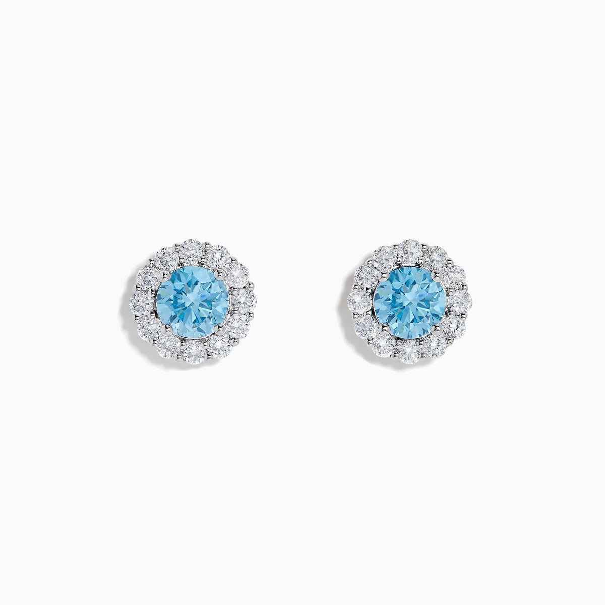Lab Grown Blue Diamond Halo Stud Earrings in 14K White Gold feature round lab grown blue diamonds encircled by halos of white diamonds, set in a circular design on a white background.