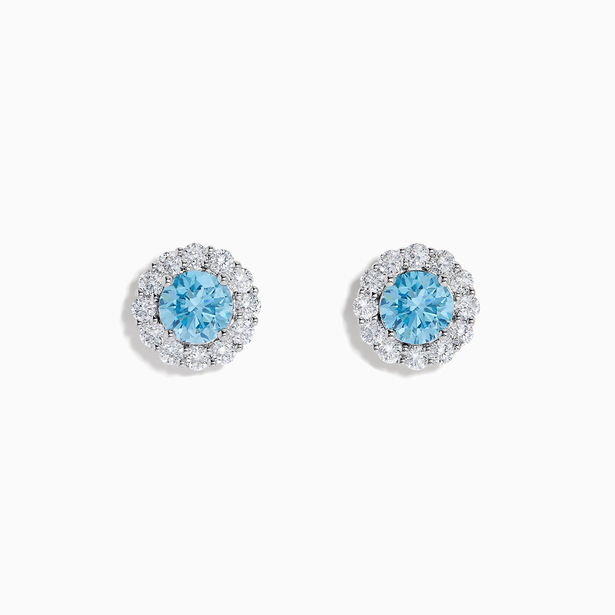 Lab Grown Blue Diamond Halo Stud Earrings in 14K White Gold feature round lab grown blue diamonds encircled by halos of white diamonds, set in a circular design on a white background.