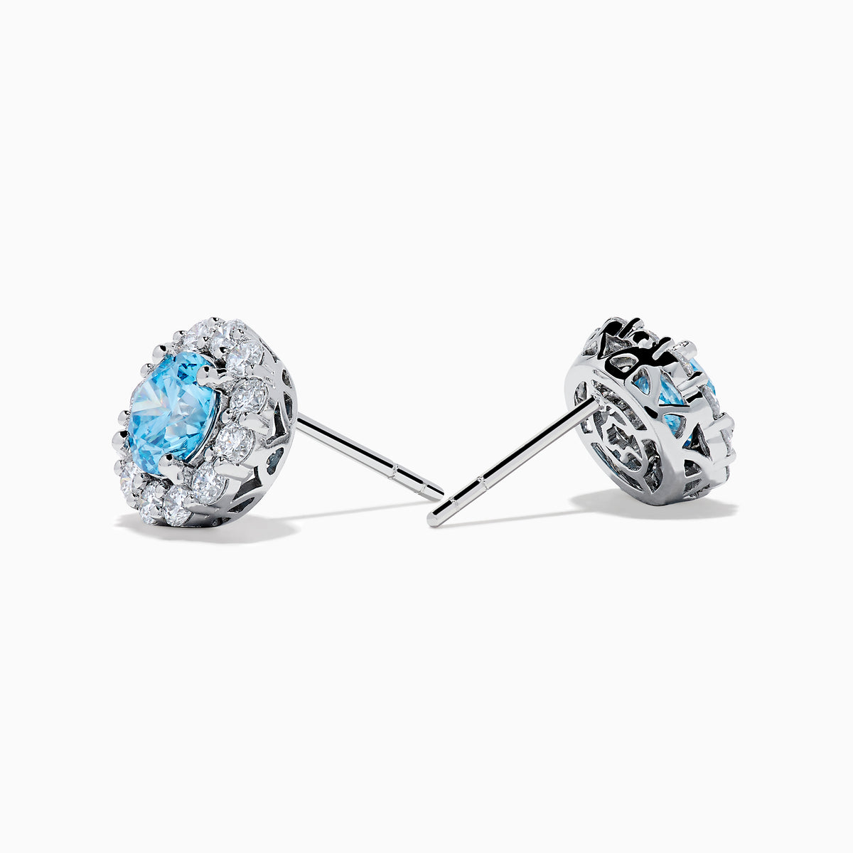 Lab Grown Blue Diamond Halo Stud Earrings in 14K White Gold feature round lab grown blue diamonds encircled by halos of white diamonds, set in a circular design on a white background.