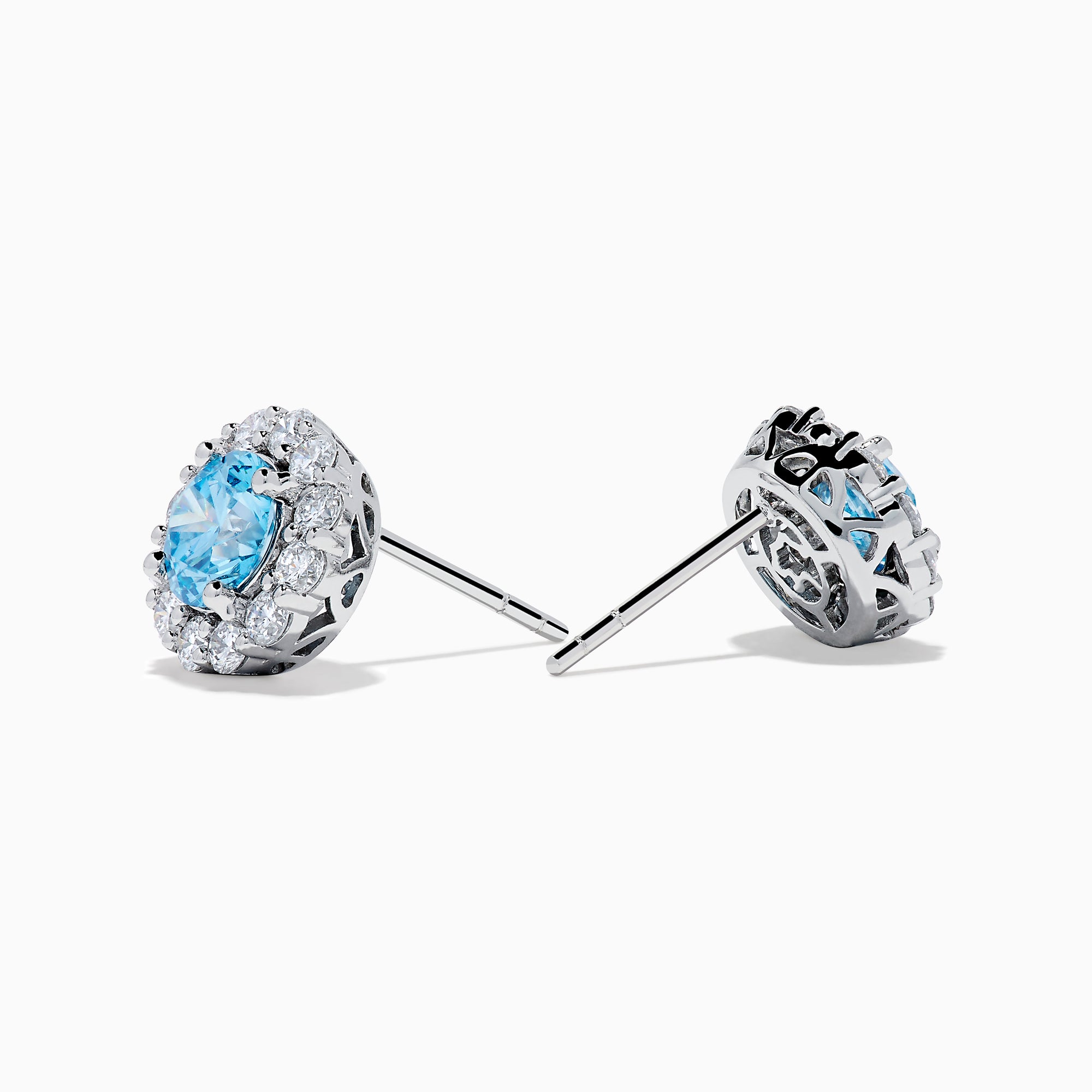 Lab Grown Blue Diamond Halo Stud Earrings in 14K White Gold feature round lab grown blue diamonds encircled by halos of white diamonds, set in a circular design on a white background.