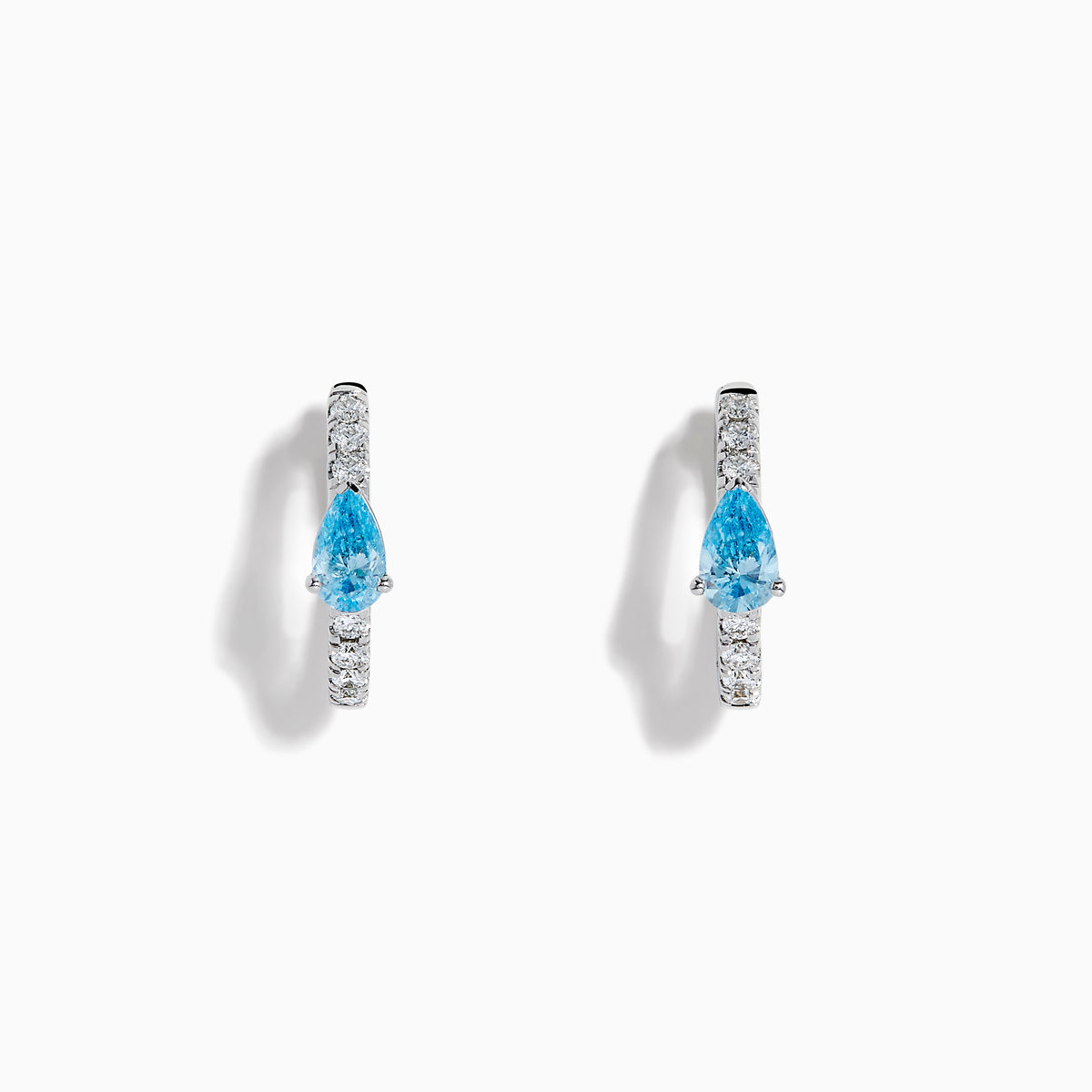 Lab Grown Blue and White Diamond Hoop Earrings in 14K White Gold, each with a teardrop-shaped blue gemstone and sparkling lab grown diamonds along the hoops, shown against a white background.