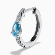 A pair of Lab Grown Blue and White Diamond Hoop Earrings in 14K White Gold, featuring a large pear-shaped blue gemstone and a row of small lab grown diamonds, is shown on a white background.