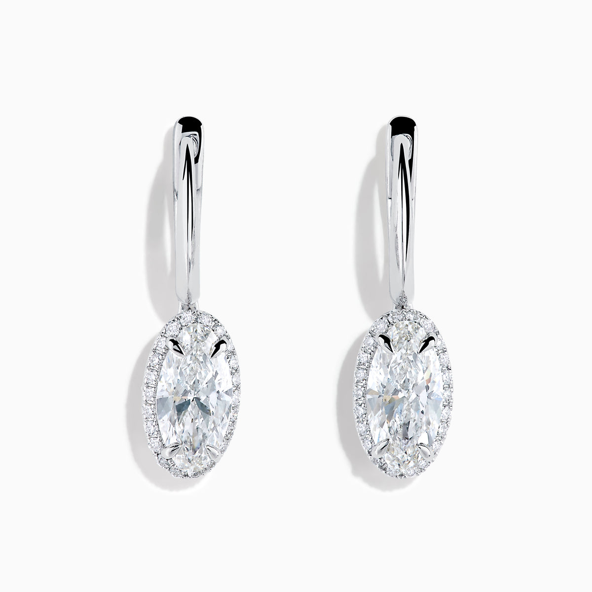 The Lab Grown Diamond Elongated Oval Drop Earrings in 14K White Gold feature clear gemstones surrounded by lab grown diamonds, set in polished white gold with a simple hook design, displayed against a white background.