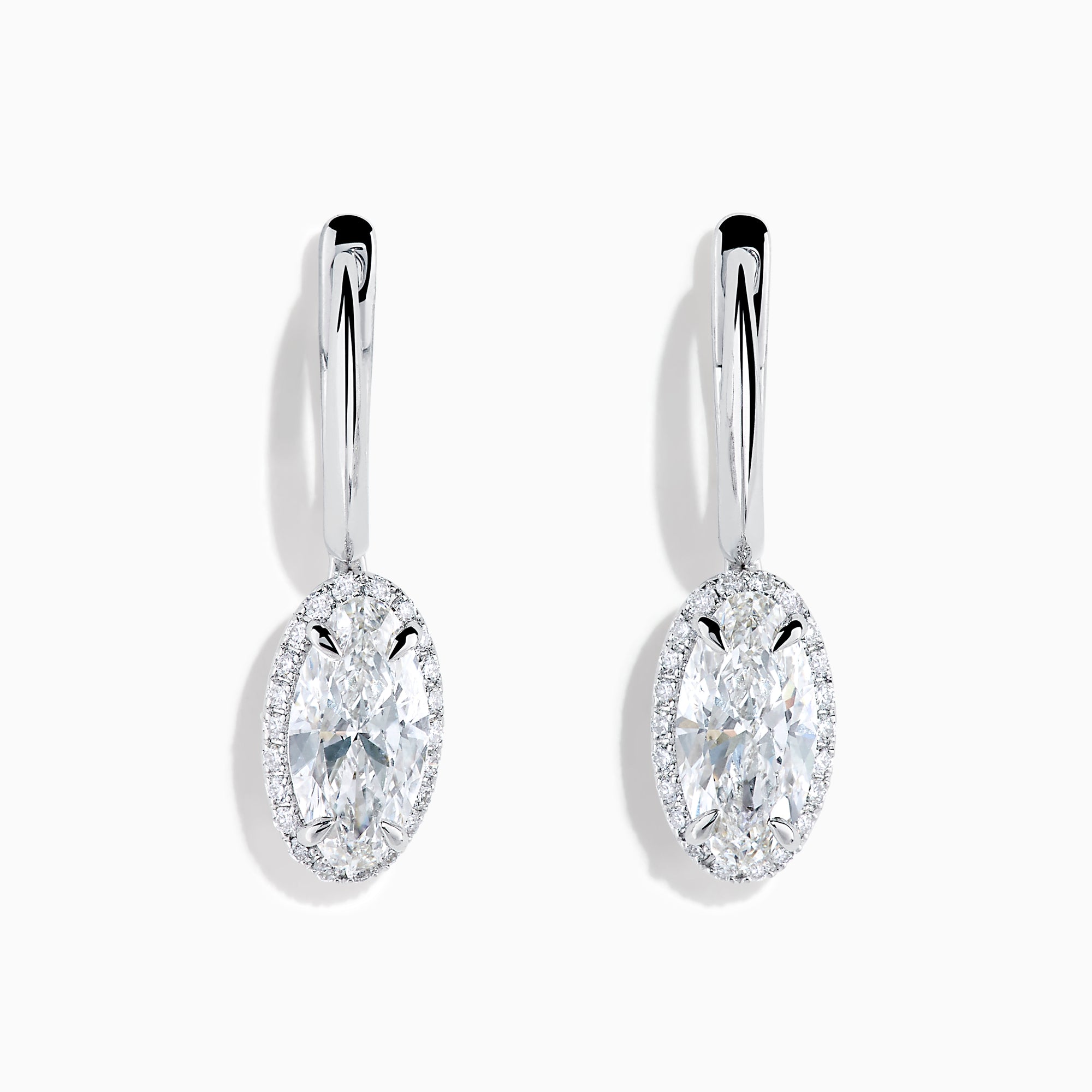 The Lab Grown Diamond Elongated Oval Drop Earrings in 14K White Gold feature clear gemstones surrounded by lab grown diamonds, set in polished white gold with a simple hook design, displayed against a white background.