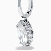 The Lab Grown Diamond Elongated Oval Drop Earrings in 14K White Gold feature clear gemstones surrounded by lab grown diamonds, set in polished white gold with a simple hook design, displayed against a white background.