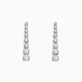 The 925 Sterling Silver Diamond Linear Drop Earrings showcase a vertical row of round, graduated diamonds that increase in size towards the bottom.