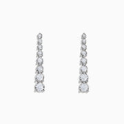 The 925 Sterling Silver Diamond Linear Drop Earrings showcase a vertical row of round, graduated diamonds that increase in size towards the bottom.
