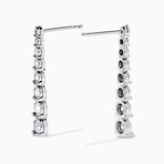 The 925 Sterling Silver Diamond Linear Drop Earrings showcase a vertical row of round, graduated diamonds that increase in size towards the bottom.