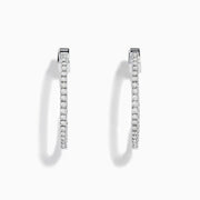 The Pave Classica 14K White Gold Diamond Hoop Earrings, encrusted with sparkling diamonds, are shown against a white background with soft shadows cast to the left.