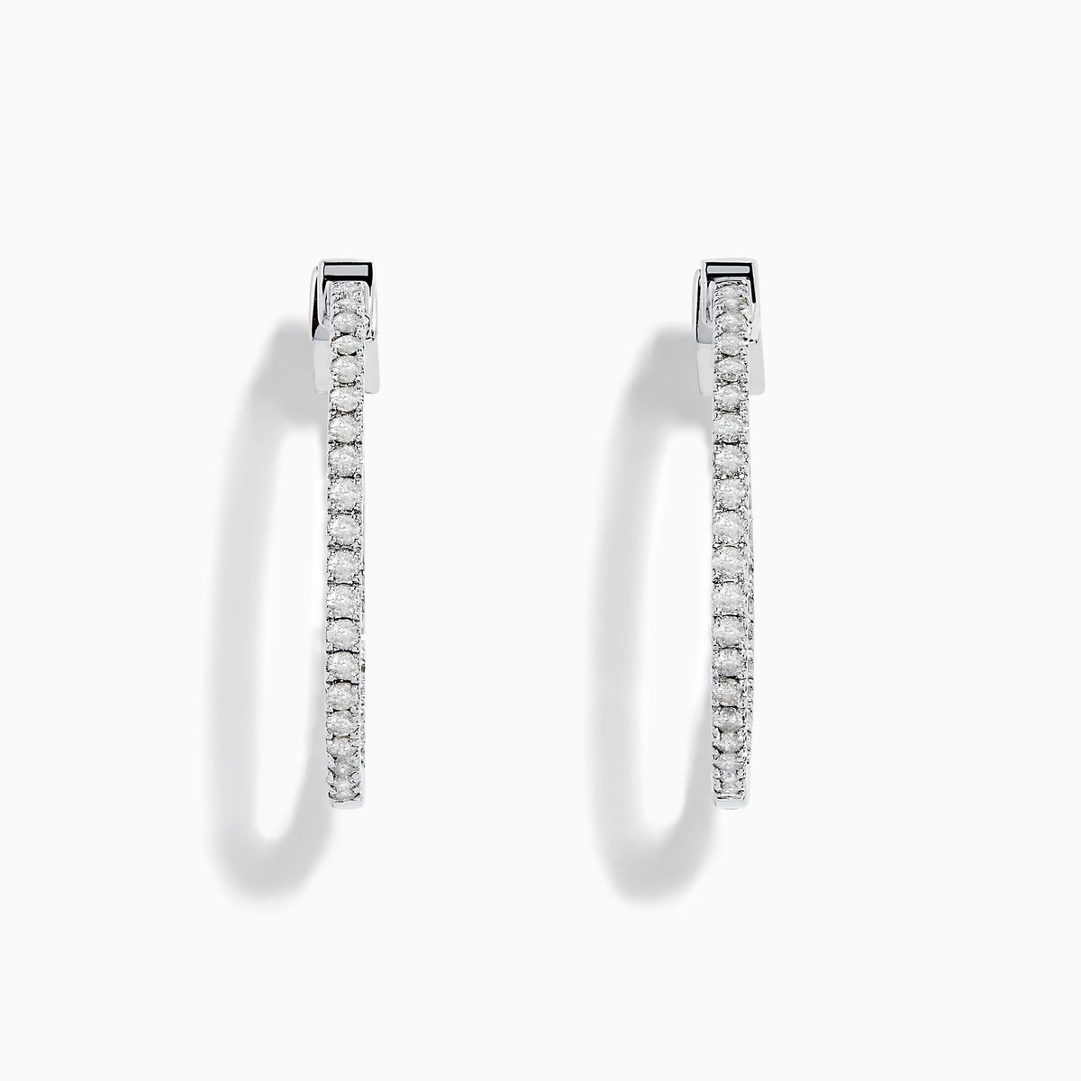 The Pave Classica 14K White Gold Diamond Hoop Earrings, encrusted with sparkling diamonds, are shown against a white background with soft shadows cast to the left.