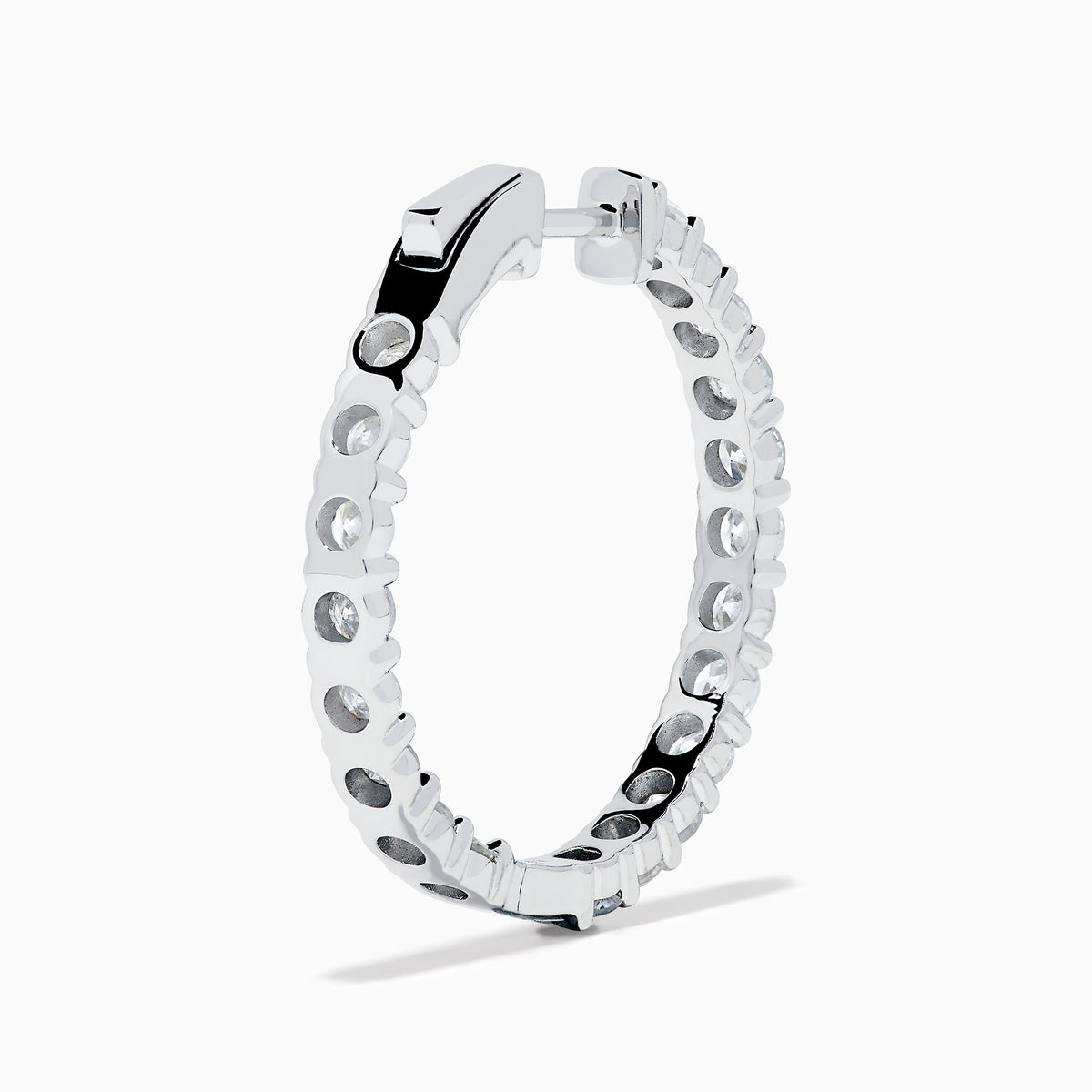 A stunning pair of 14K White Gold Diamond Inside Out 1" Hoop Earrings, each adorned with a row of brilliant round white diamonds, displayed vertically against a white background with soft shadows. These hoop earrings are designed in an inside out style, ensuring each diamond sparkles beautifully from every angle.