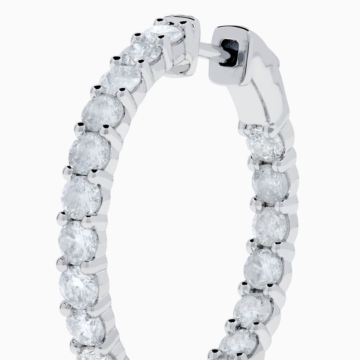 A stunning pair of 14K White Gold Diamond Inside Out 1" Hoop Earrings, each adorned with a row of brilliant round white diamonds, displayed vertically against a white background with soft shadows. These hoop earrings are designed in an inside out style, ensuring each diamond sparkles beautifully from every angle.