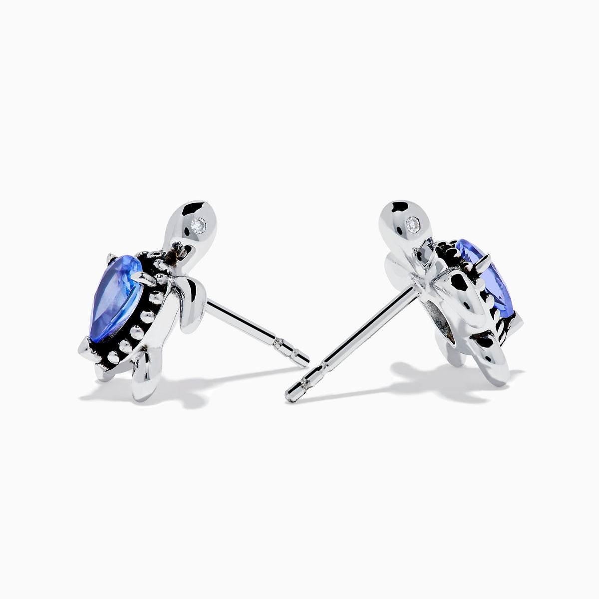 A pair of 925 Silver Tanzanite and Diamond Turtle Stud Earrings, featuring turtle shapes with blue tanzanite centers, displayed on a white background.