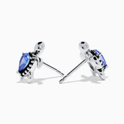 A pair of 925 Silver Tanzanite and Diamond Turtle Stud Earrings, featuring turtle shapes with blue tanzanite centers, displayed on a white background.